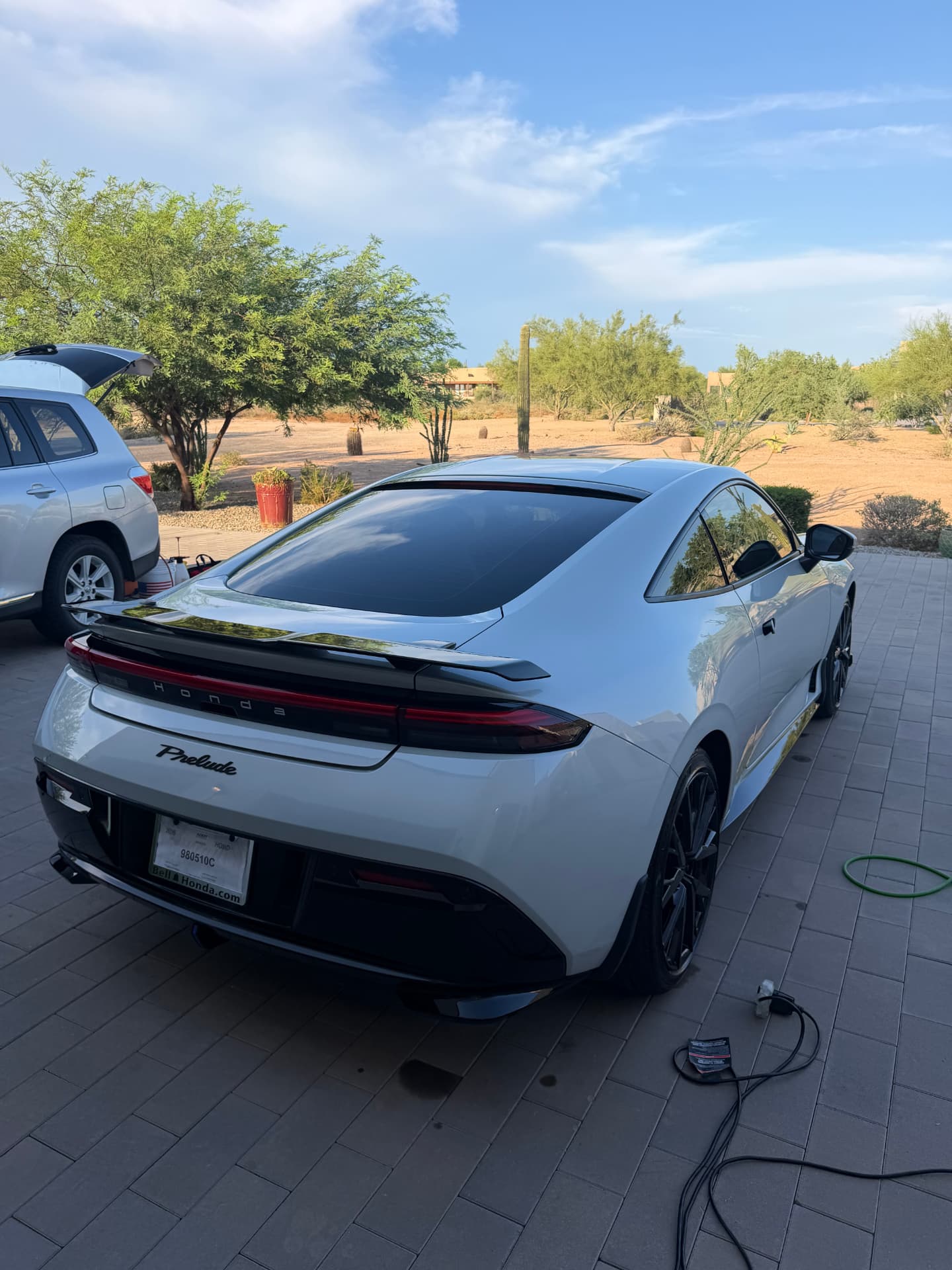 Freshly detailed white Honda Prelude in a Phoenix driveway